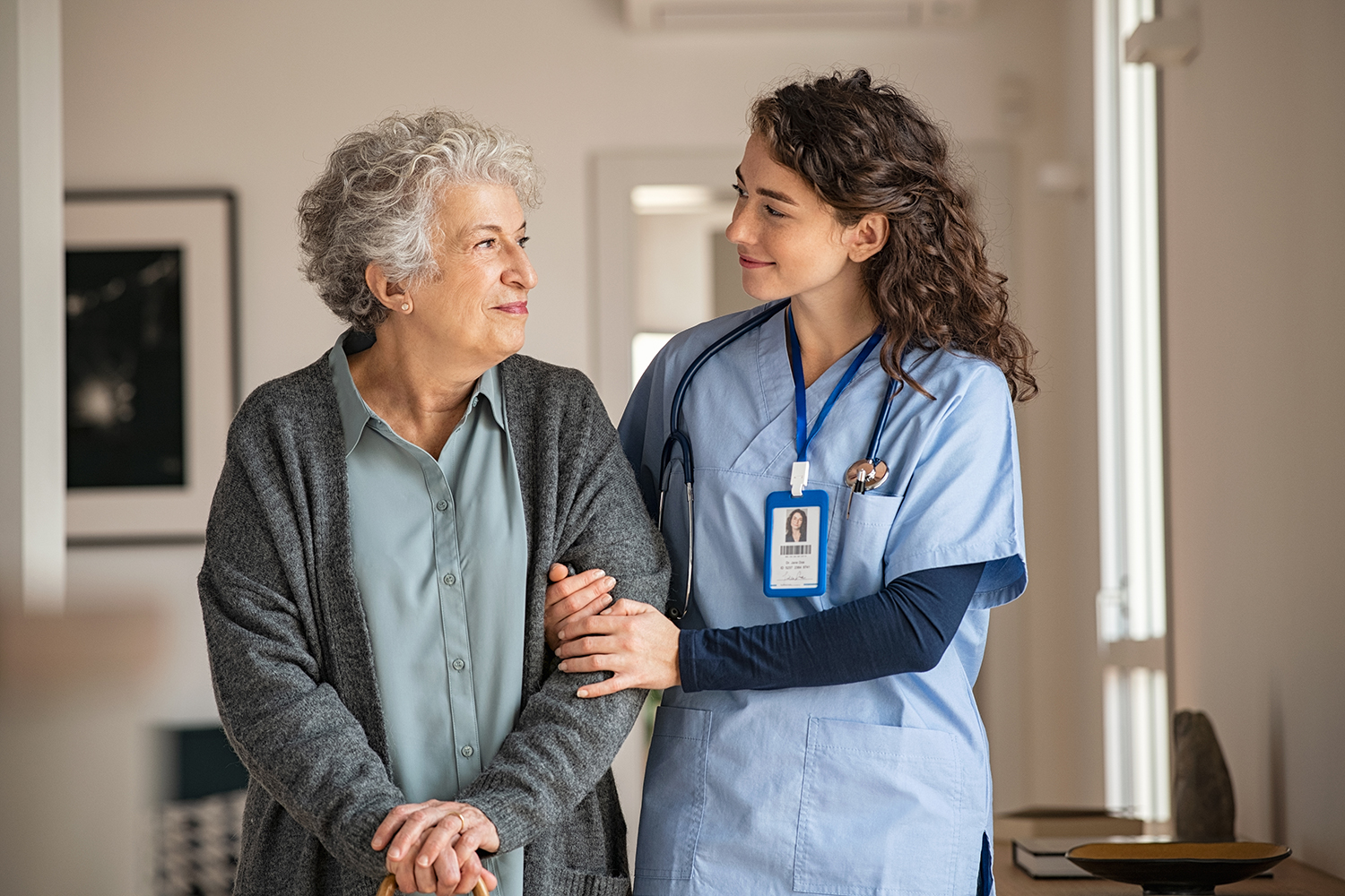 Caregiver assisting an older woman at home