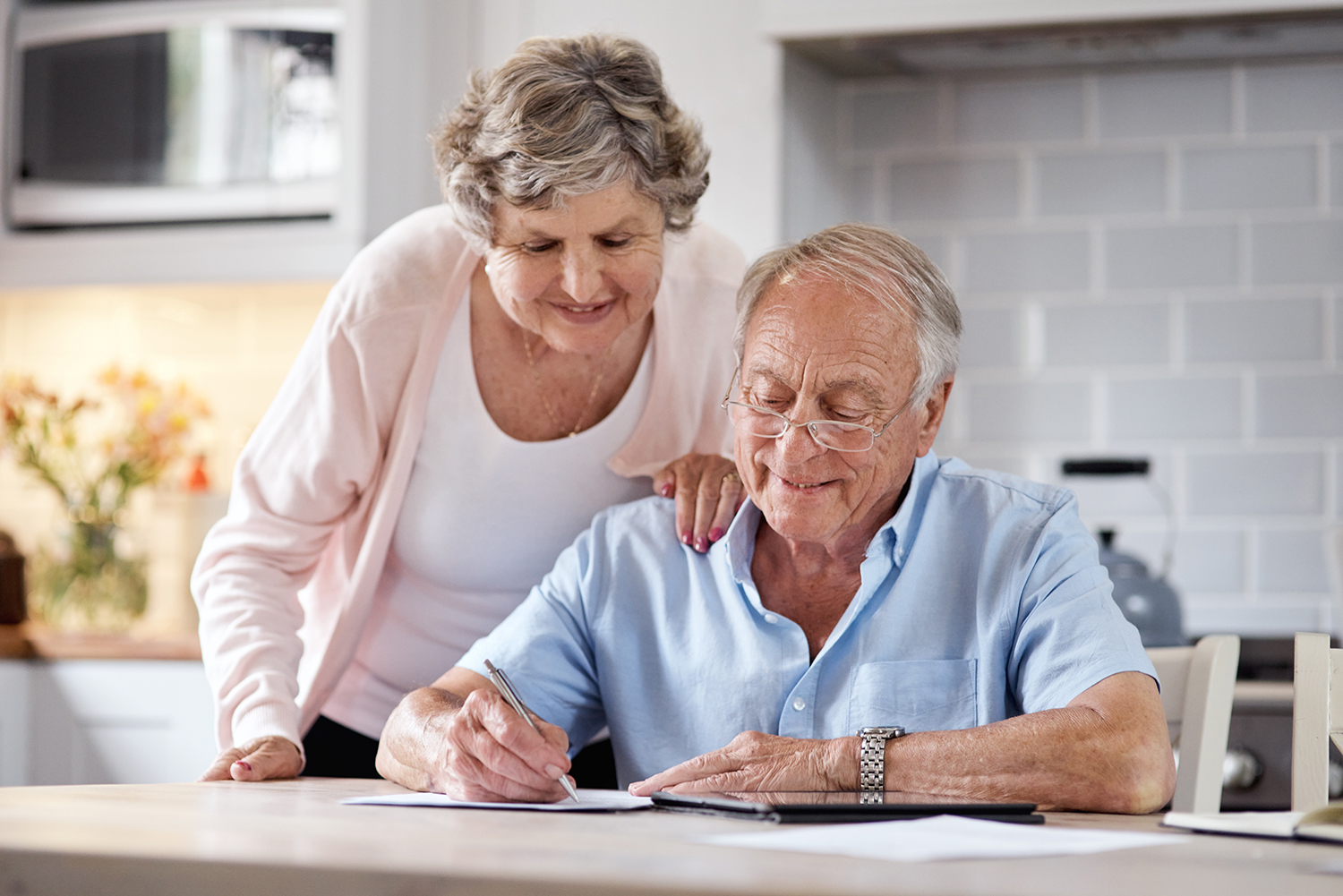 Older couple reviewing paperwork at home